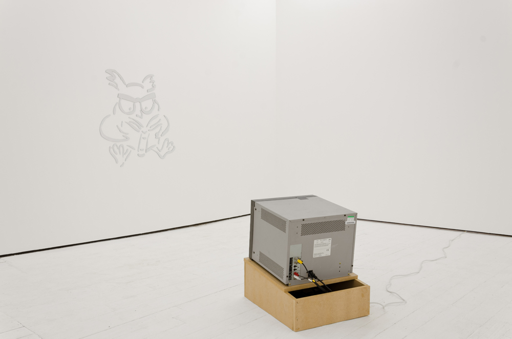 White gallery with mirrored owl drawing facing a tilted up cube monitor