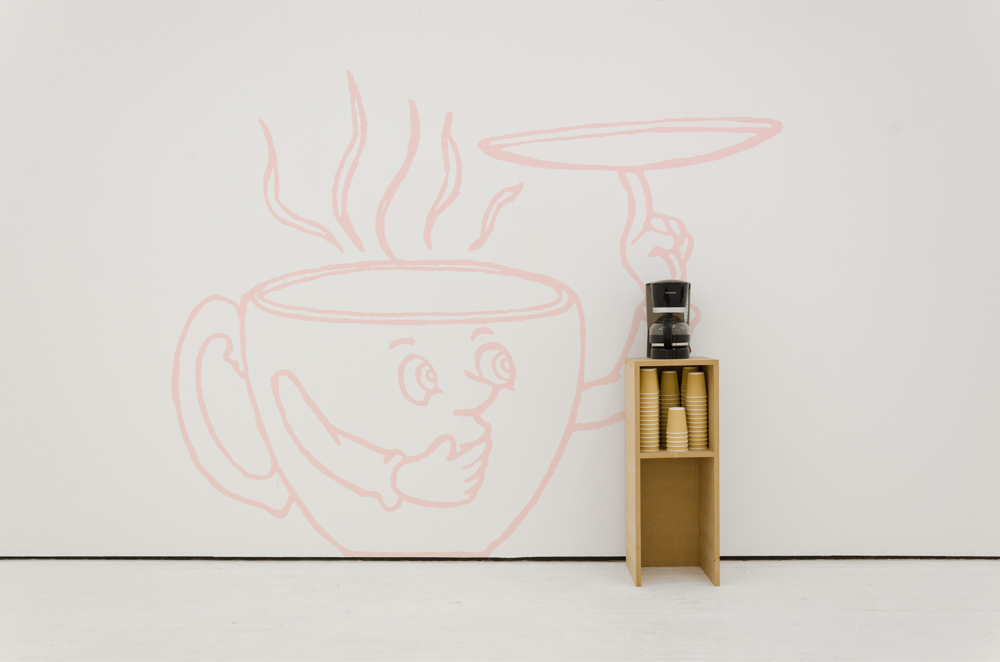 White gallery with pink painting of a cartoon coffee cup, and a plinth with a coffee machine