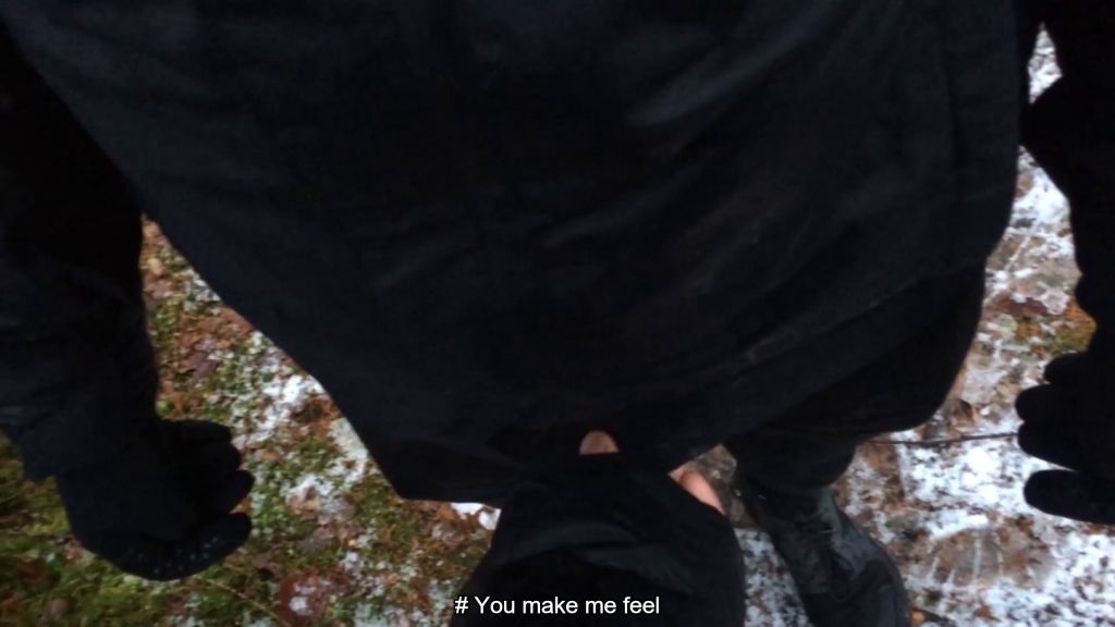 Hand touching the crotch of a figure in all black outerwear with the caption '# You make me feel'