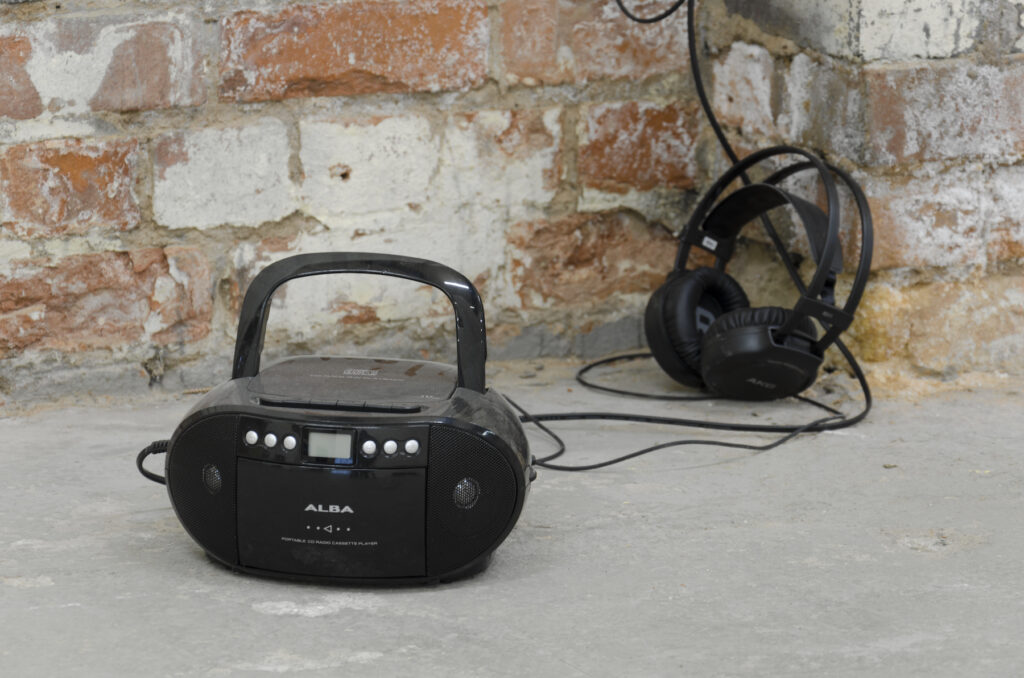 a black alba cd boombox with a headphones