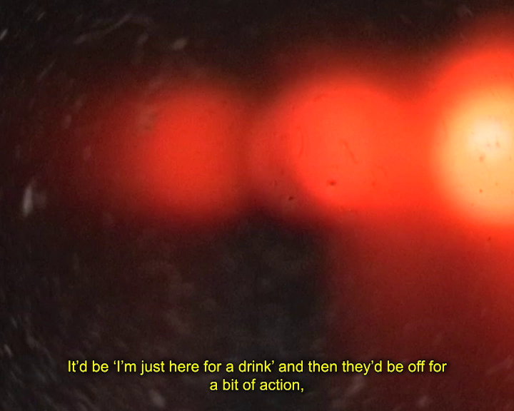 Blurry red and orange lights with visible water droplets creating an abstract effect. Caption reads ‘It’d be ‘I’m just here for a drink’ and then they’d be off for a bit of action,’.